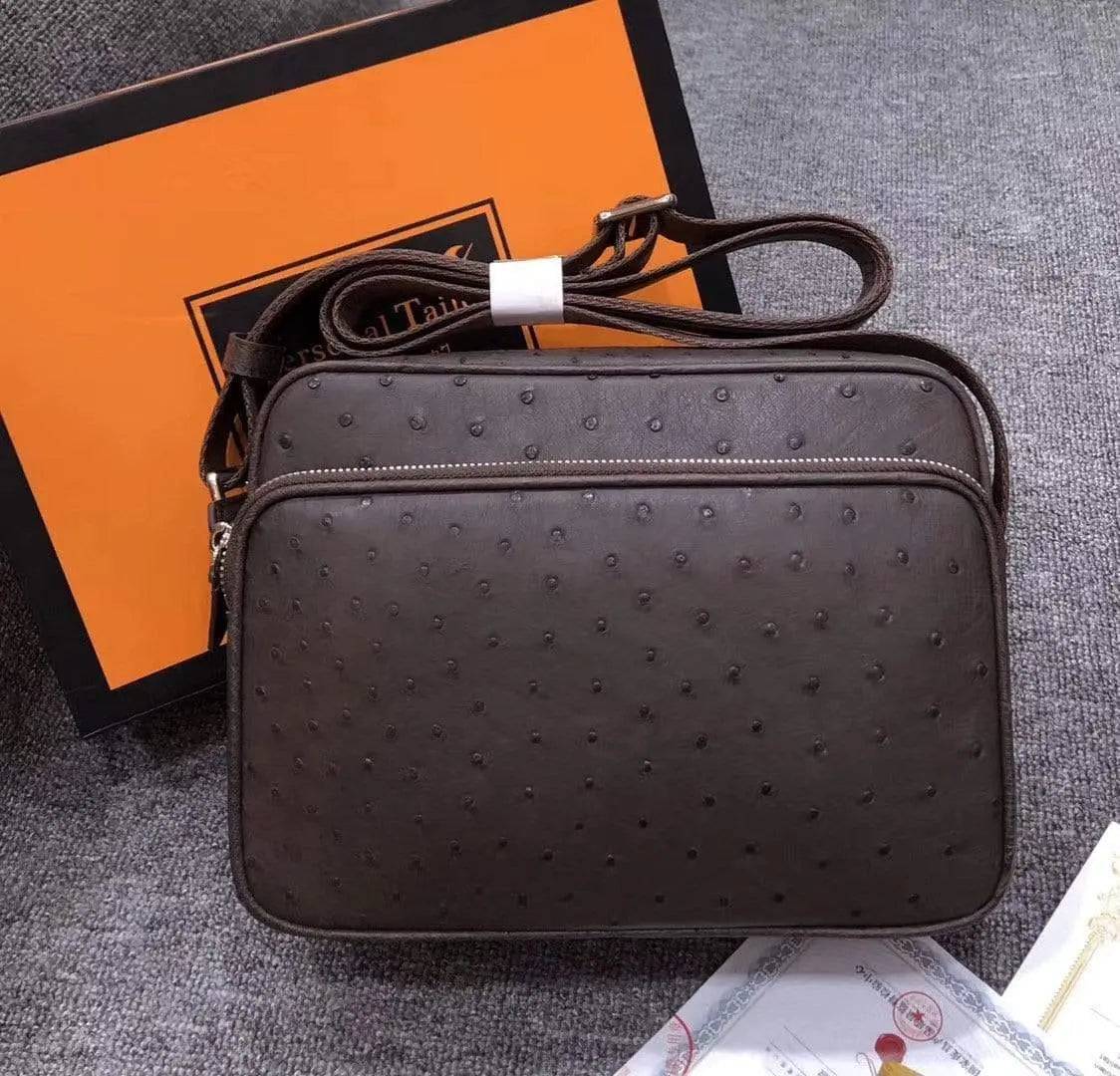 Mens messenger bag by Rossie Viren made of ostrich leather, featuring a cross-body shoulder strap and classic handbag design.