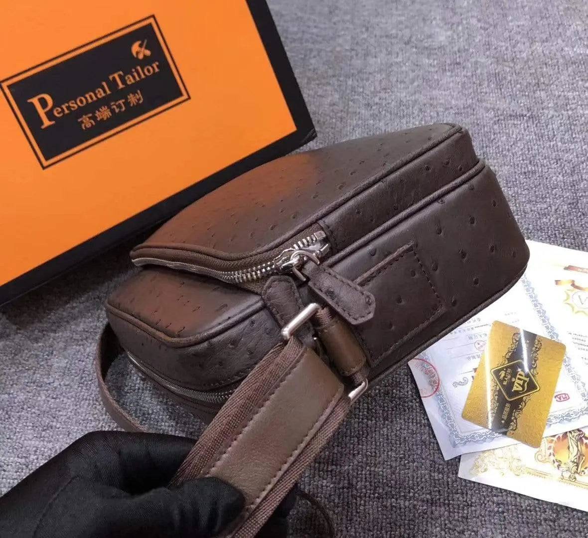 Men's messenger bag made of ostrich leather, cross-body shoulder bag with adjustable strap and multiple compartments.