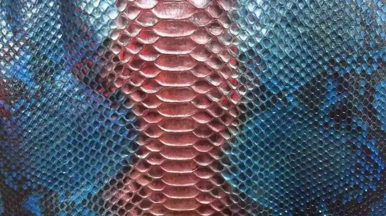 Close-up of python skin leather in vibrant colorway, showcasing textured reptile pattern on luxury apparel and accessories by Rossieviren.