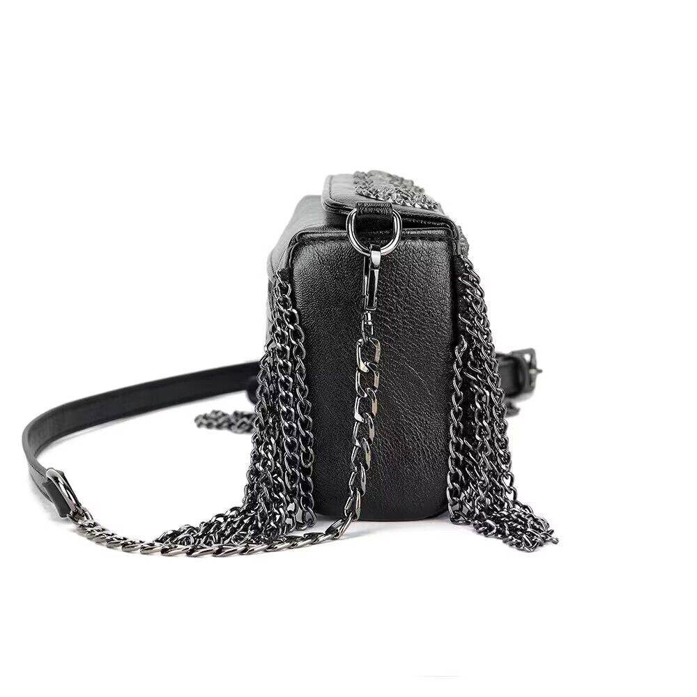 Rossie Viren 3D skull shoulder bag with studded chain strap, featuring a bold design and textured surface.