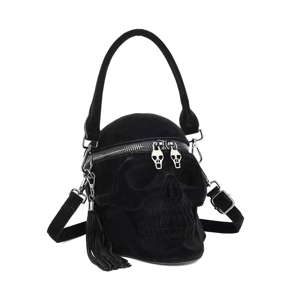 Black suede 3D skull crossbody handle bag by Rossie Viren, featuring a mini size with shoulder strap and hand-held handle.