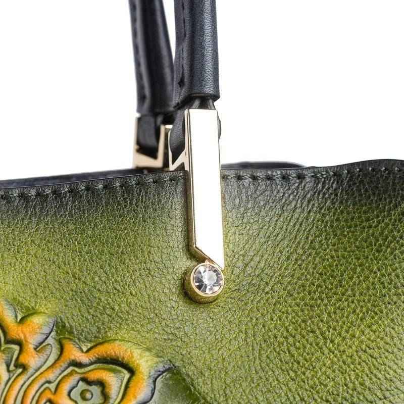 Rossie Viren women's leather handbag with top handle and crossbody strap, featuring a sleek design and gold-tone hardware.