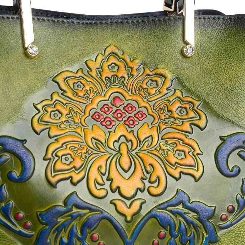 Rossie Viren women's leather handbag with top handle and crossbody strap, featuring sleek design and organized interior.