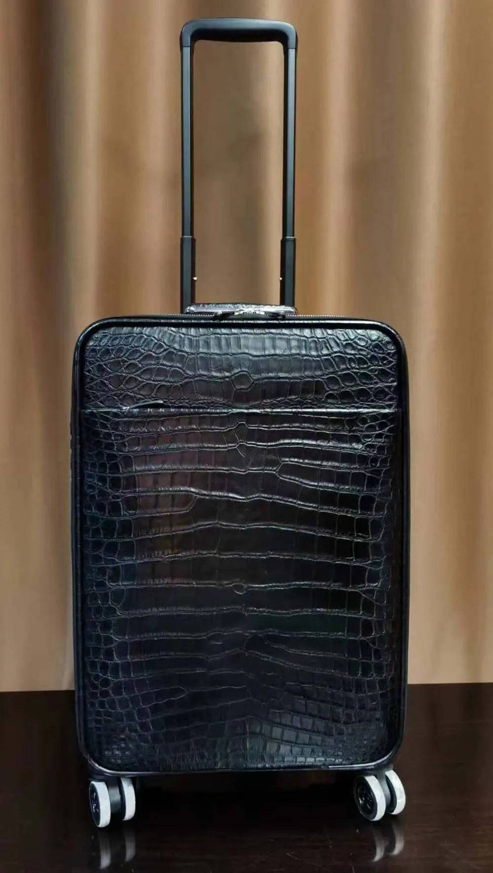 Rossie Viren crocodile skin leather 20-inch black travel suitcase with universal wheels and trolley handle on a travel bag.
