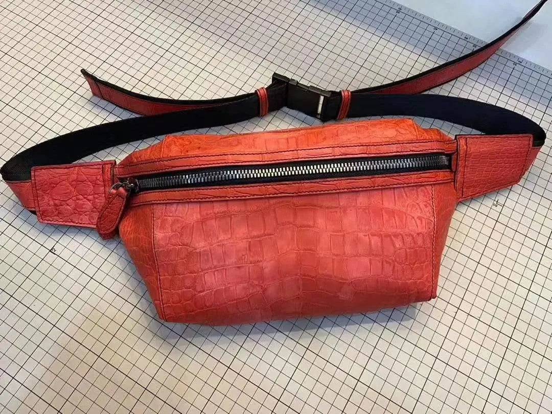 Unisex crocodile leather waist fanny pack by Rossie Viren with adjustable strap and multiple compartments, worn around the waist.