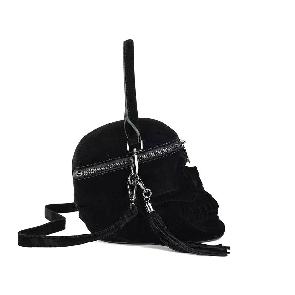 Black suede 3D skull crossbody handle bag with mini handle from Rossie Viren featuring a stylish, edgy design.