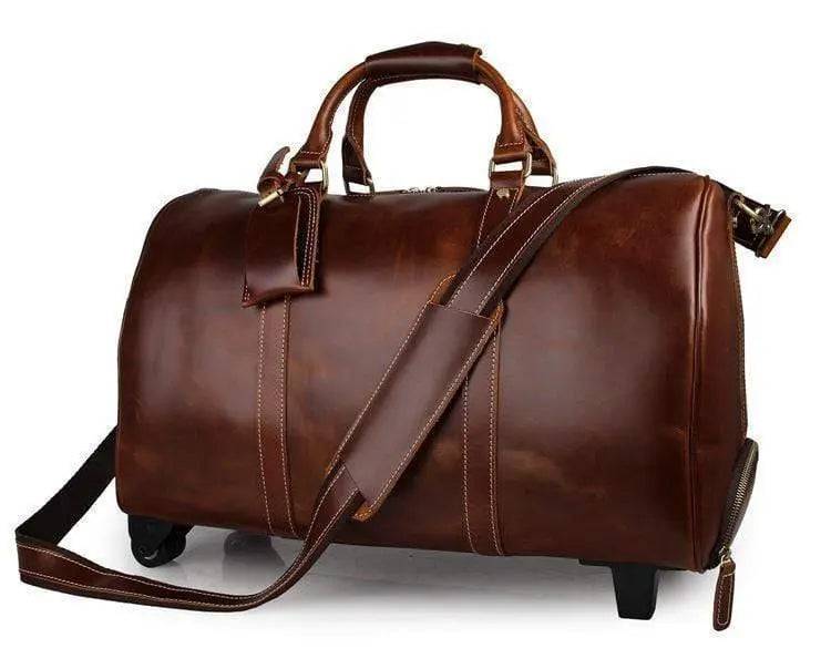 Vintage tan leather Rossie Viren carry-on luggage bag with sturdy handles and classic design, suitable for travel.