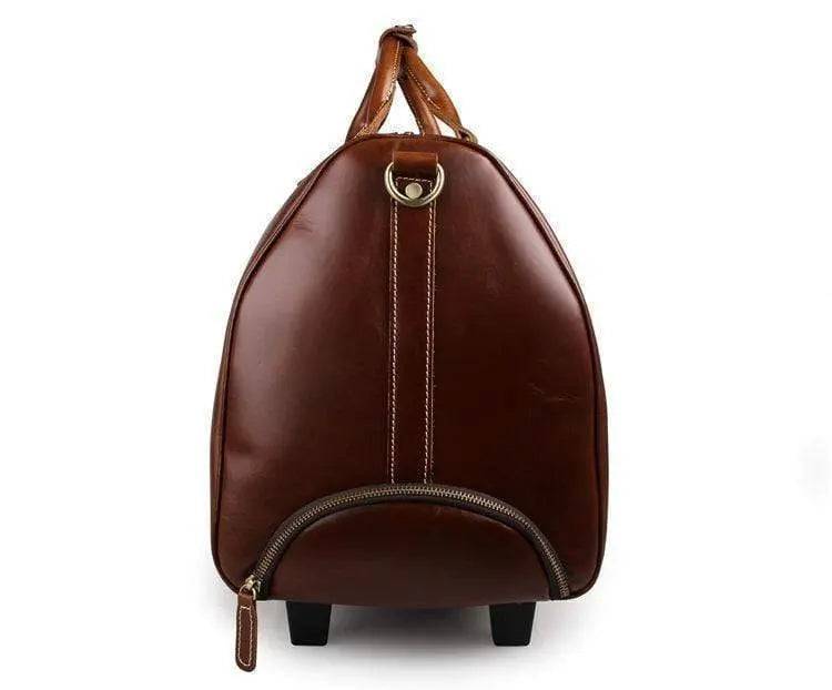 Vintage tan leather Rossie Viren carry-on luggage bag with sturdy handles and classic design, perfect for travel.