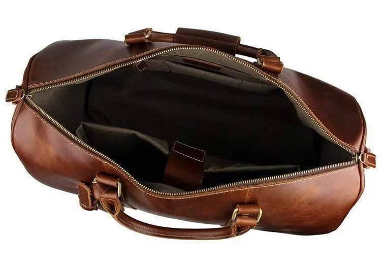 Vintage tan leather Rossie Viren handbag with carry-on luggage style design, featuring sturdy handles and classic leather finish.