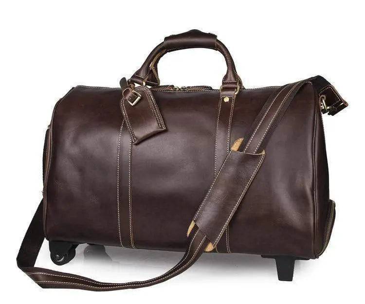 Vintage tan leather Rossie Viren carry-on luggage handbag with sturdy handles and classic design.