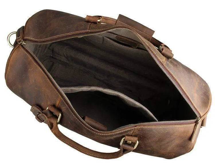 Vintage tan leather Rossie Viren carry-on luggage handbag with sturdy handle and classic design.