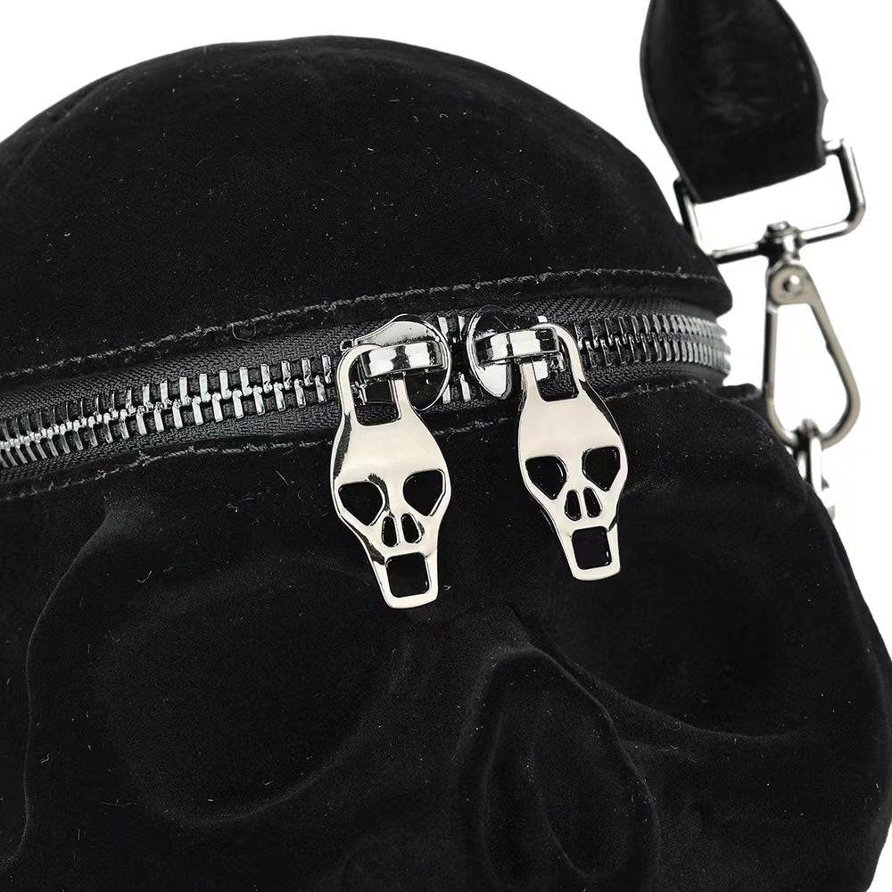 Black suede skull crossbody handle bag by Rossie Viren, featuring a mini size with a shoulder strap and stylish design.