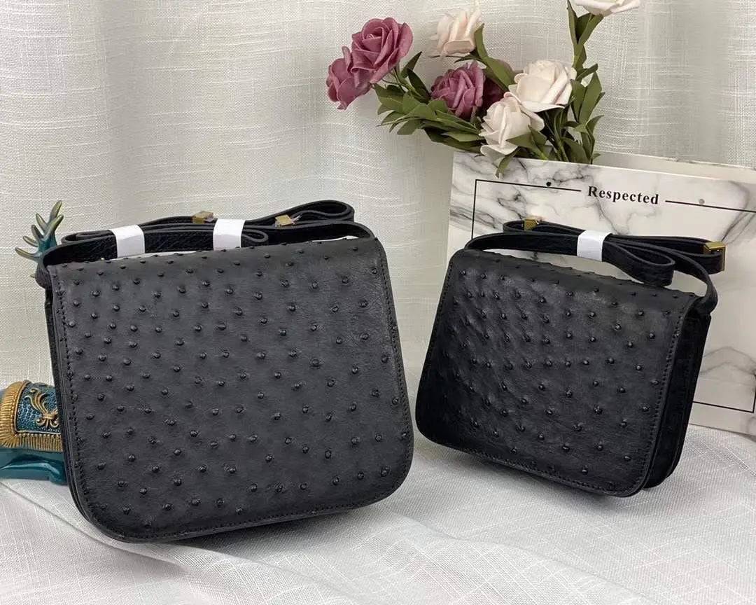 Women’s ostrich leather cross body messenger shoulder bag by Rossie Viren, featuring a sleek design and textured leather finish.