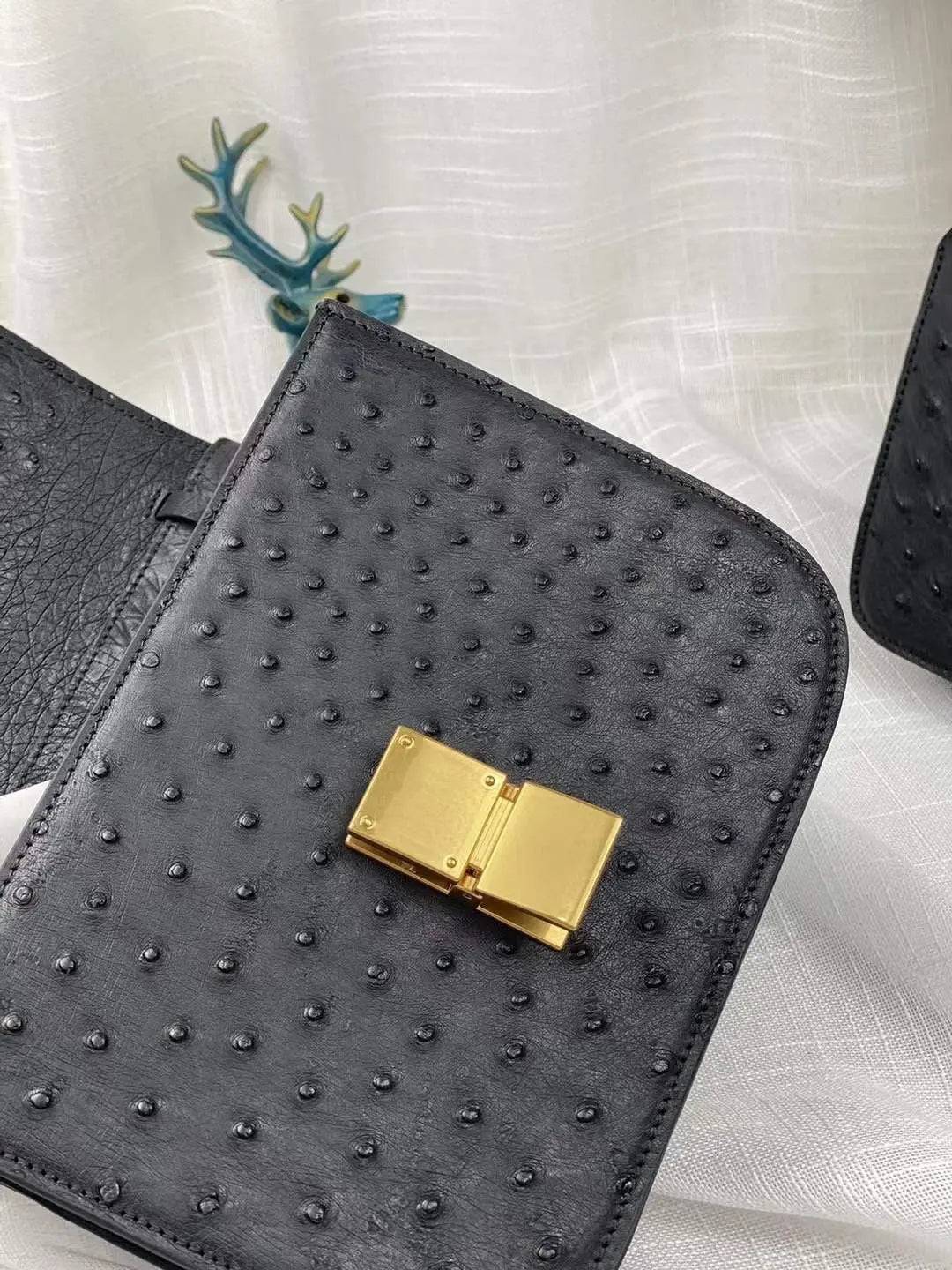 Women’s ostrich leather cross body messenger handbag by Rossie Viren with adjustable shoulder strap and sleek design.