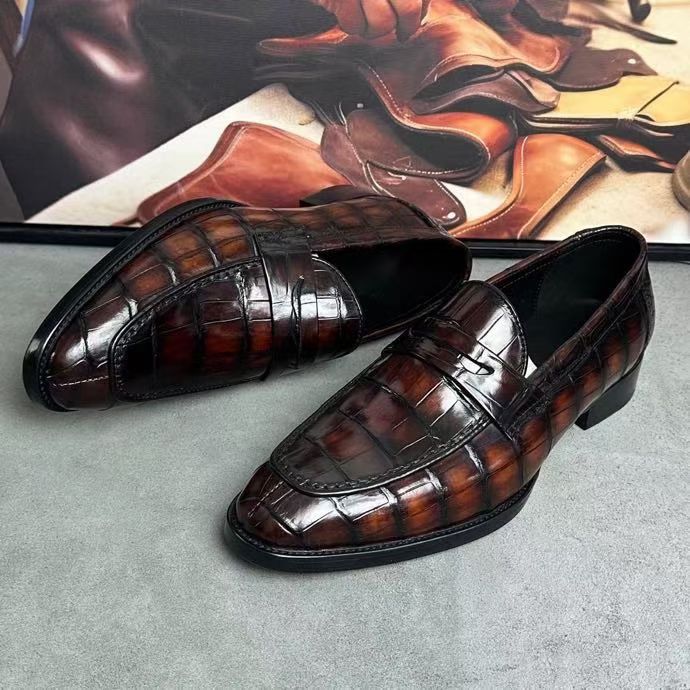 Vintage brown crocodile leather loafers by Rossie Viren, showcasing sleek design and textured crocodile pattern.