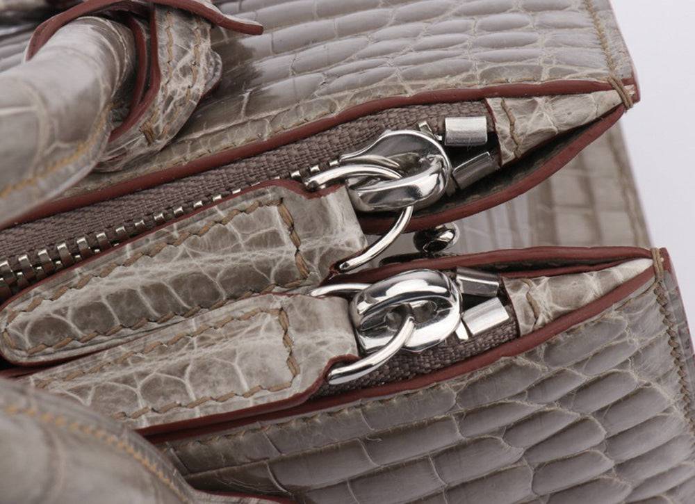 Shiny crocodile skin leather crossbody handbag with beaded accents and top handle by Rossie Viren.