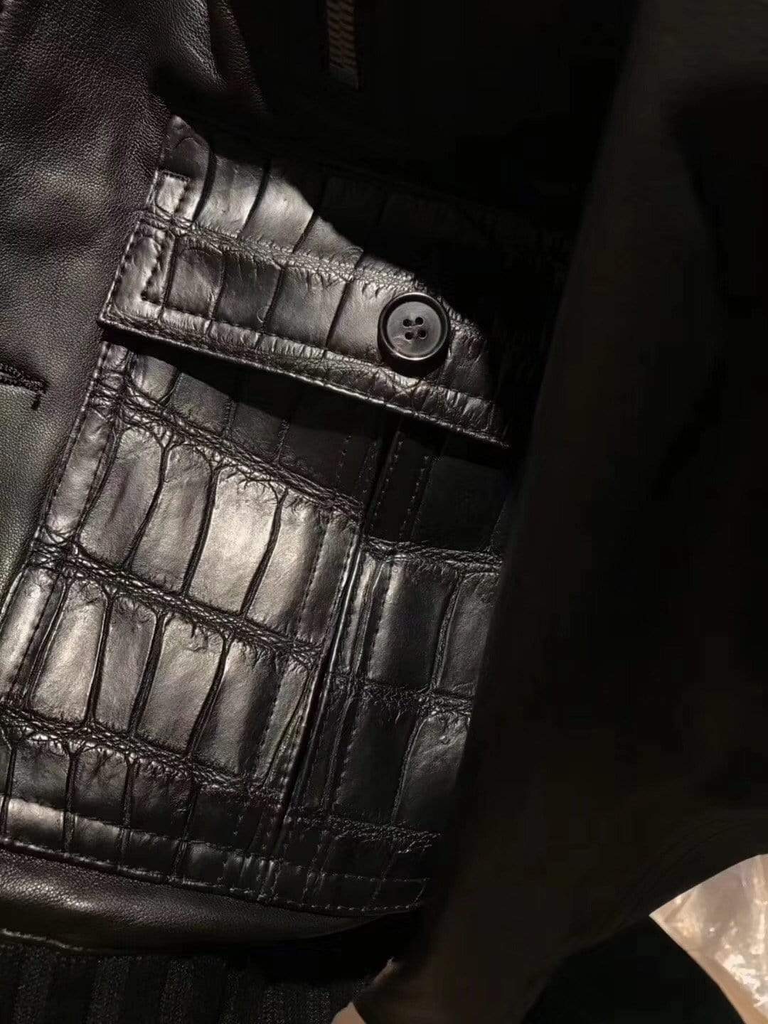 Rossie Viren black crocodile leather jacket with ribbed jersey cuffs and collar, showcasing a sleek, textured design.