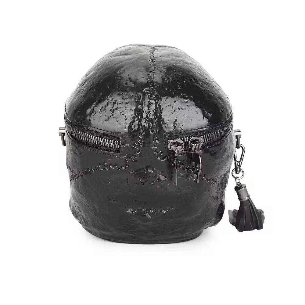 Black 3D skull crossbody handle bag by Rossie Viren, featuring a compact design with a mini handle and shoulder strap.