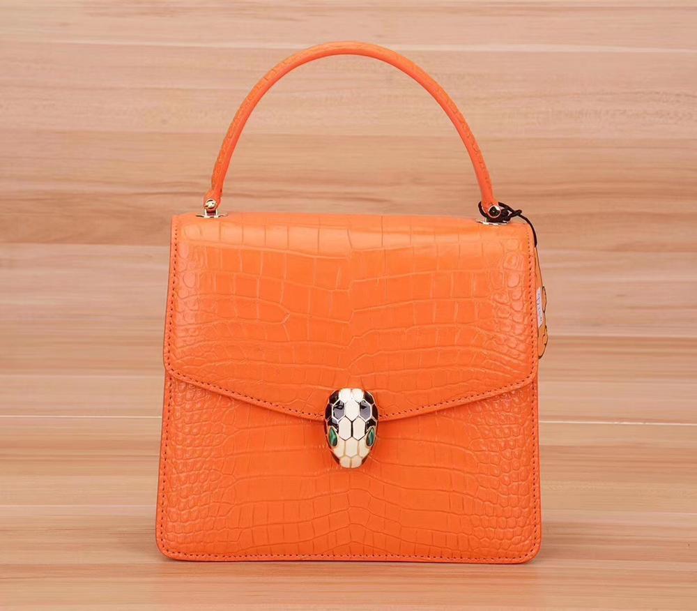 Rossie Viren crocodile leather women's chain crossbody handbag with flap closure and shoulder strap.