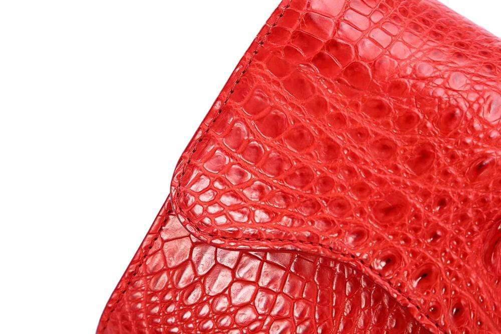 Rossie Viren crocodile leather handbag with flap and chain, featuring a clutch design and cross-body shoulder strap.