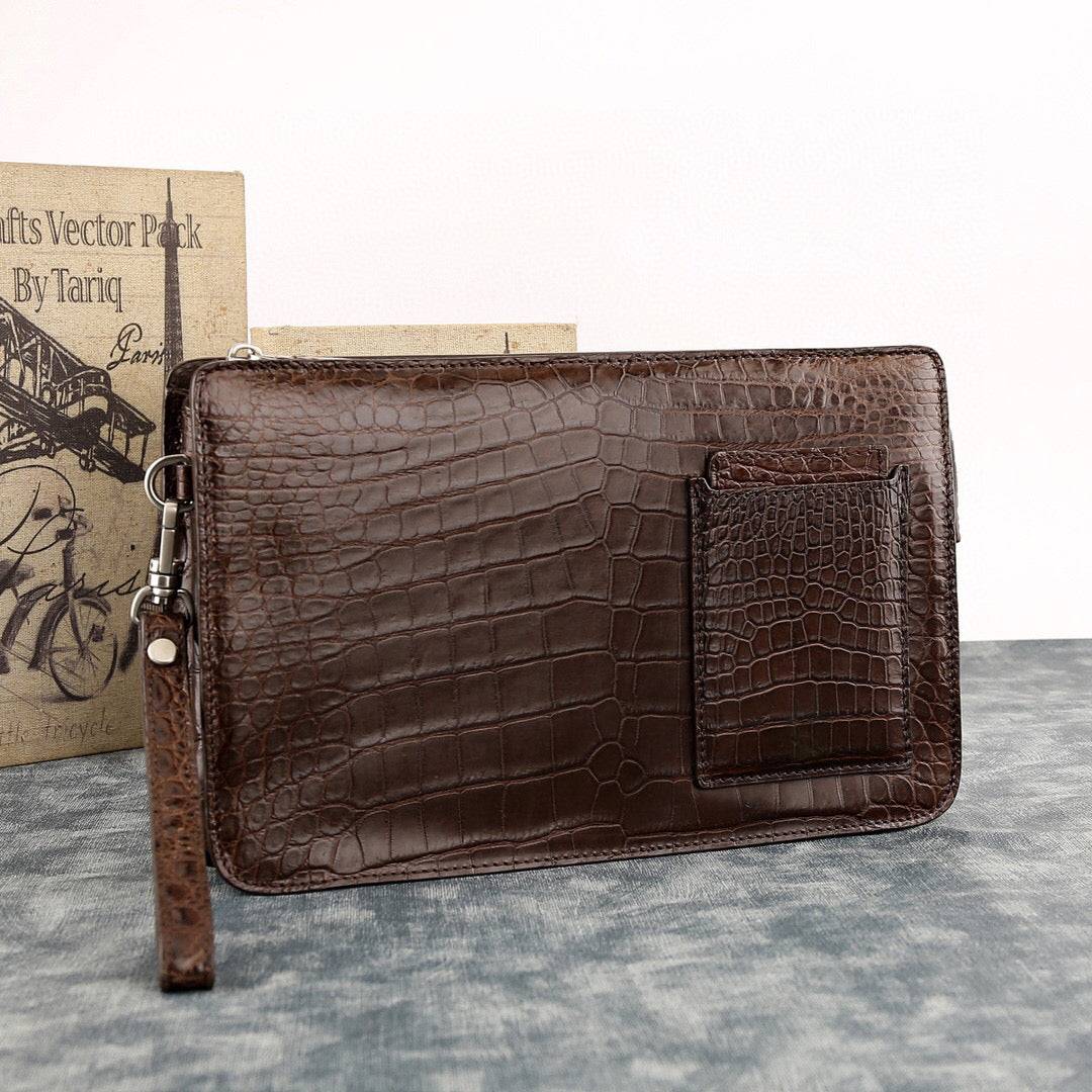 Rossie Viren crocodile leather clutch bag with large volume, designed for carrying essentials stylishly and securely.