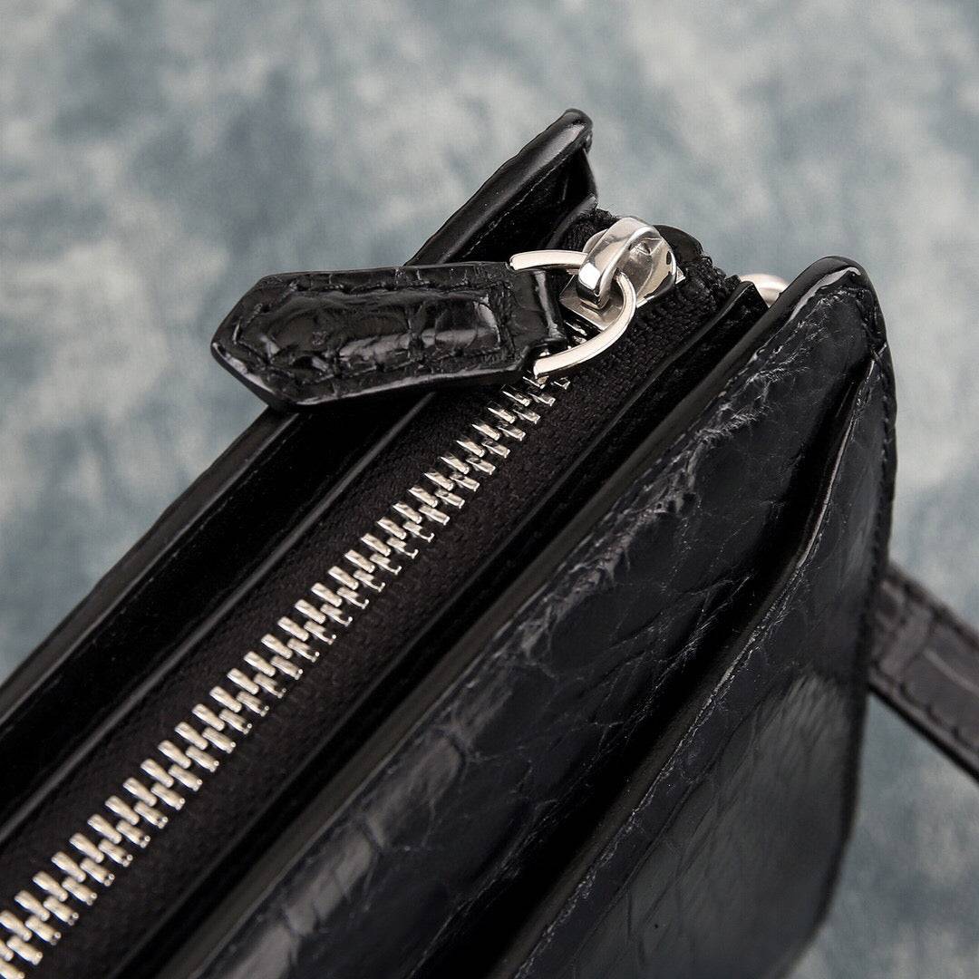 Rossie Viren crocodile leather clutch bag with large volume, designed for holding essentials and featuring a textured crocodile pattern.