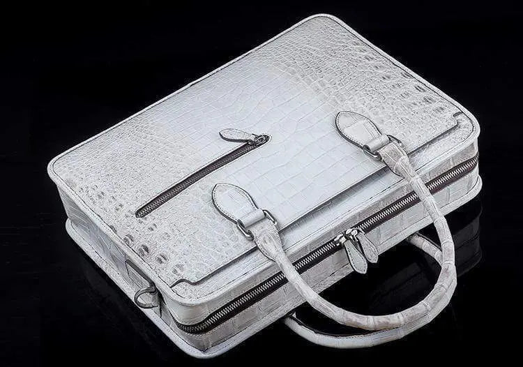 White crocodile belly leather briefcase handbag by Rossie Viren with sleek, textured crocodile pattern and sturdy handle.