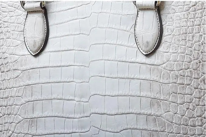 White crocodile belly leather briefcase handbag by Rossie Viren, featuring textured crocodile pattern and elegant design.