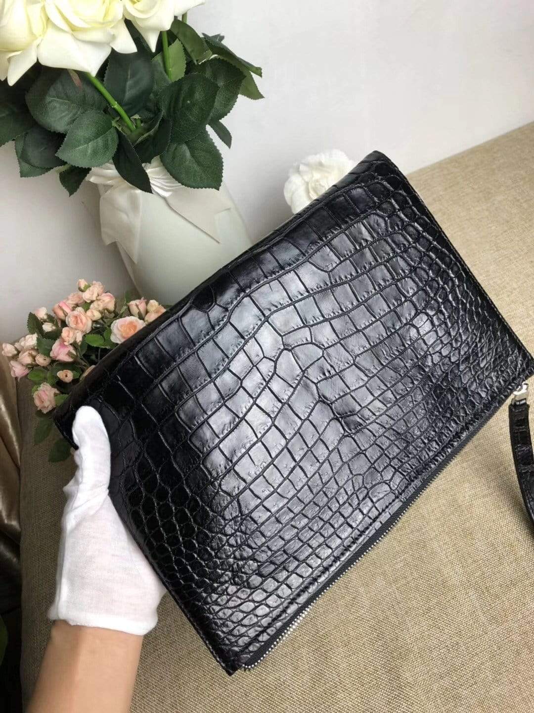 Rossie Viren crocodile belly leather large iPad clutch bag with a sleek, textured design and secure top closure.