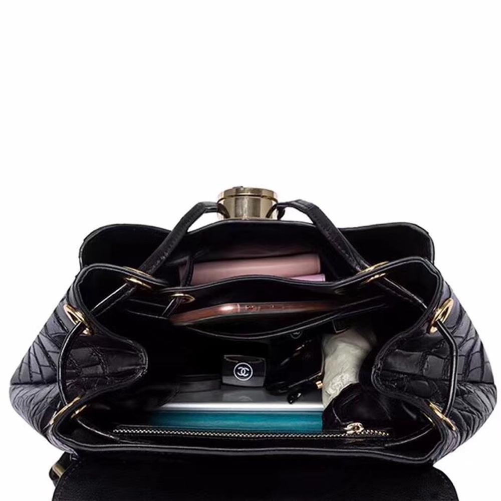 Crocodile belly leather women's backpack handbag by Rossie Viren, featuring textured crocodile pattern and adjustable straps.