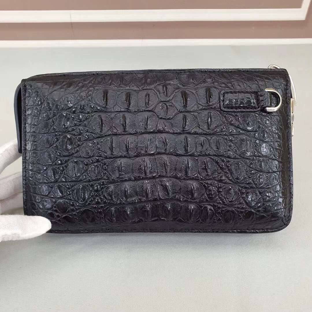 Rossie Viren crocodile bone leather clutch bag with textured crocodile pattern and sleek design.
