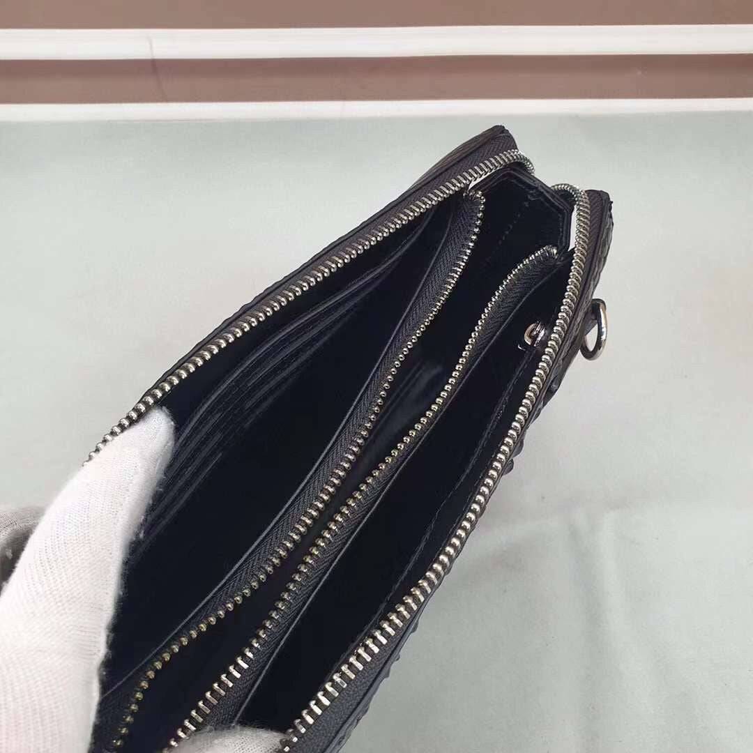 Black crocodile bone leather clutch bag with band string from Rossie Viren, featuring textured crocodile pattern and sleek design.
