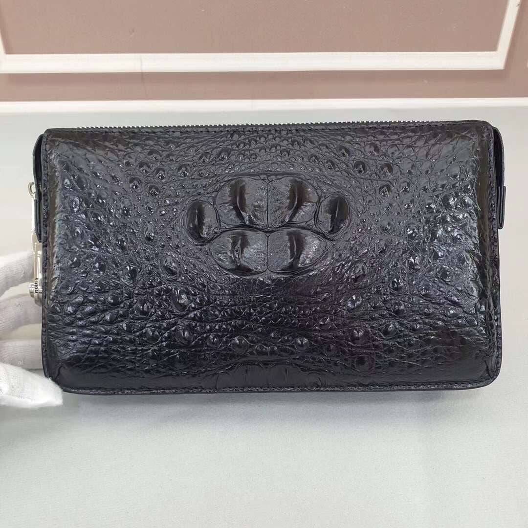 Black Rossie Viren crocodile bone leather clutch bag with band string, showcasing a sleek, textured design and elegant craftsmanship.