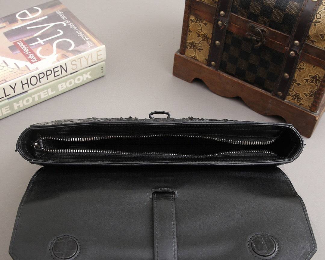 Rossie Viren crocodile bone leather clutch bag with a sleek, textured design and compact style for elegant occasions.