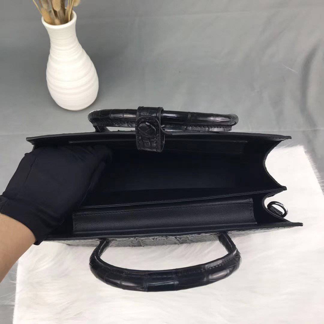 Rossie Viren crocodile bone leather handbag with top handle, featuring a sleek design and textured crocodile pattern.
