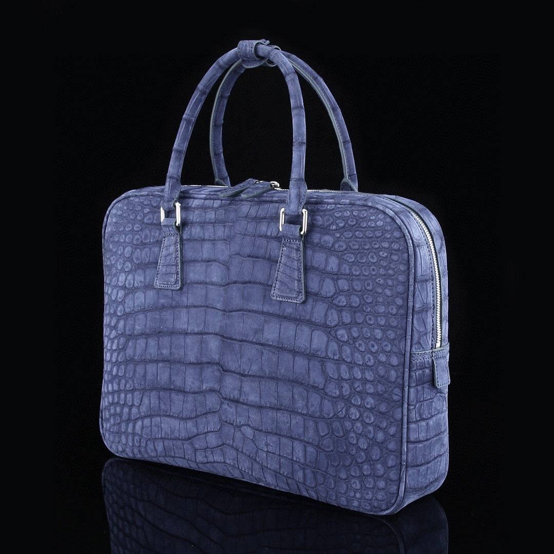 Blue genuine crocodile leather briefcase by Rossie Viren with a sleek, textured crocodile skin finish and sturdy handles.