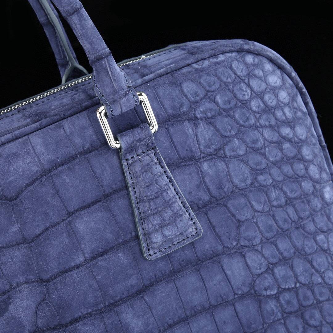 Blue genuine crocodile leather briefcase by Rossie Viren, featuring a textured crocodile skin finish and sturdy leather handles.
