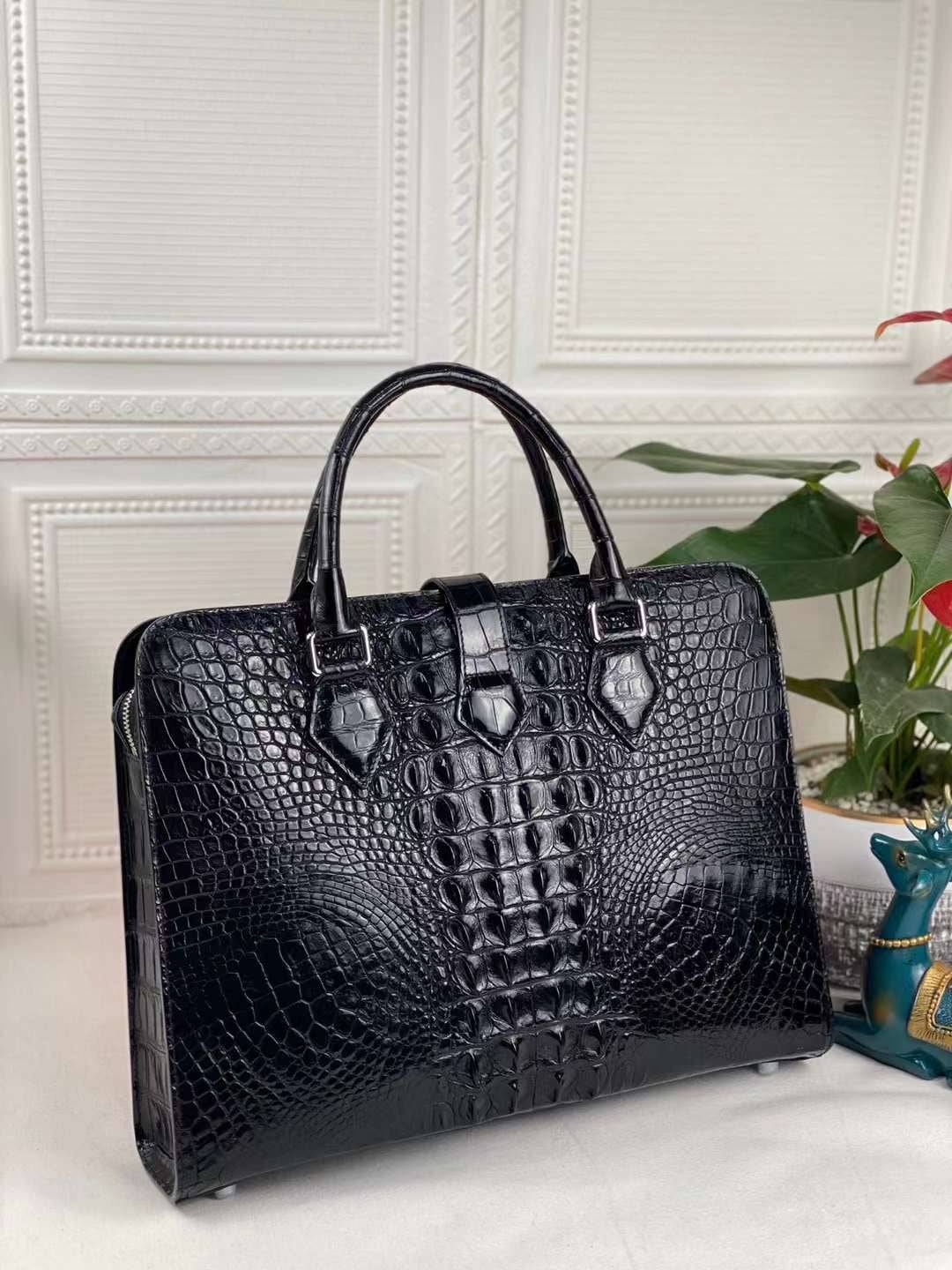 Black genuine crocodile leather briefcase from Rossie Viren, featuring a sleek design and sturdy handle for professional use.