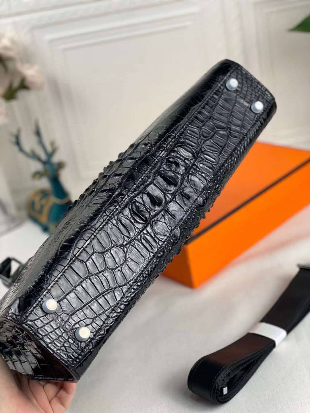 Black genuine crocodile skin leather briefcase by Rossie Viren, featuring a sleek design for carrying laptops and documents.