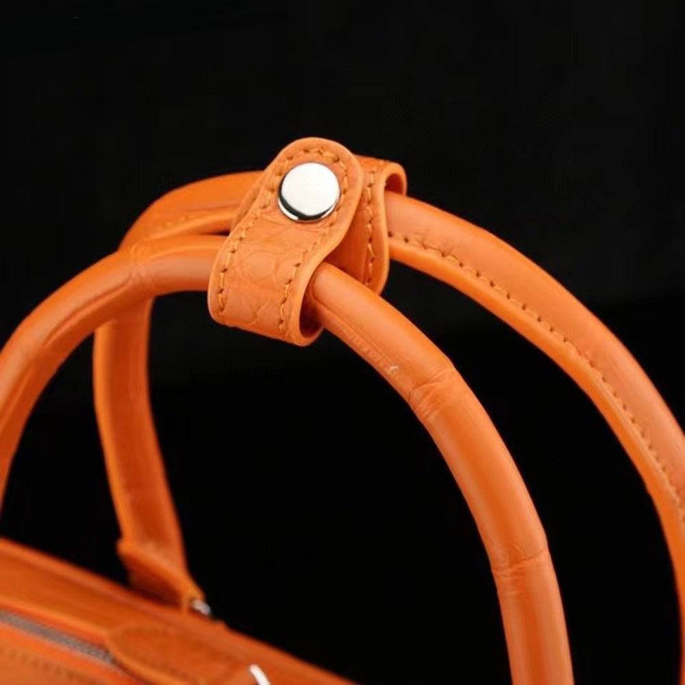 Orange genuine crocodile leather briefcase with sturdy handles, designed for laptops, by Rossie Viren.