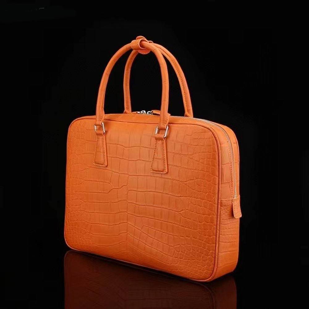 Orange Rossie Viren crocodile leather briefcase with sturdy handles and sleek design, perfect for professional laptop carrying.