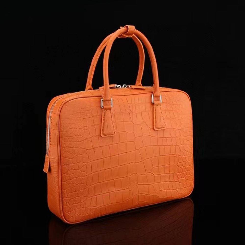 Orange Rossie Viren crocodile leather briefcase with sturdy handles and sleek design, ideal for carrying laptops and documents.