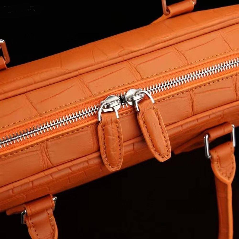 Orange genuine crocodile leather briefcase by Rossie Viren, featuring a sleek design and sturdy handles for professional use.