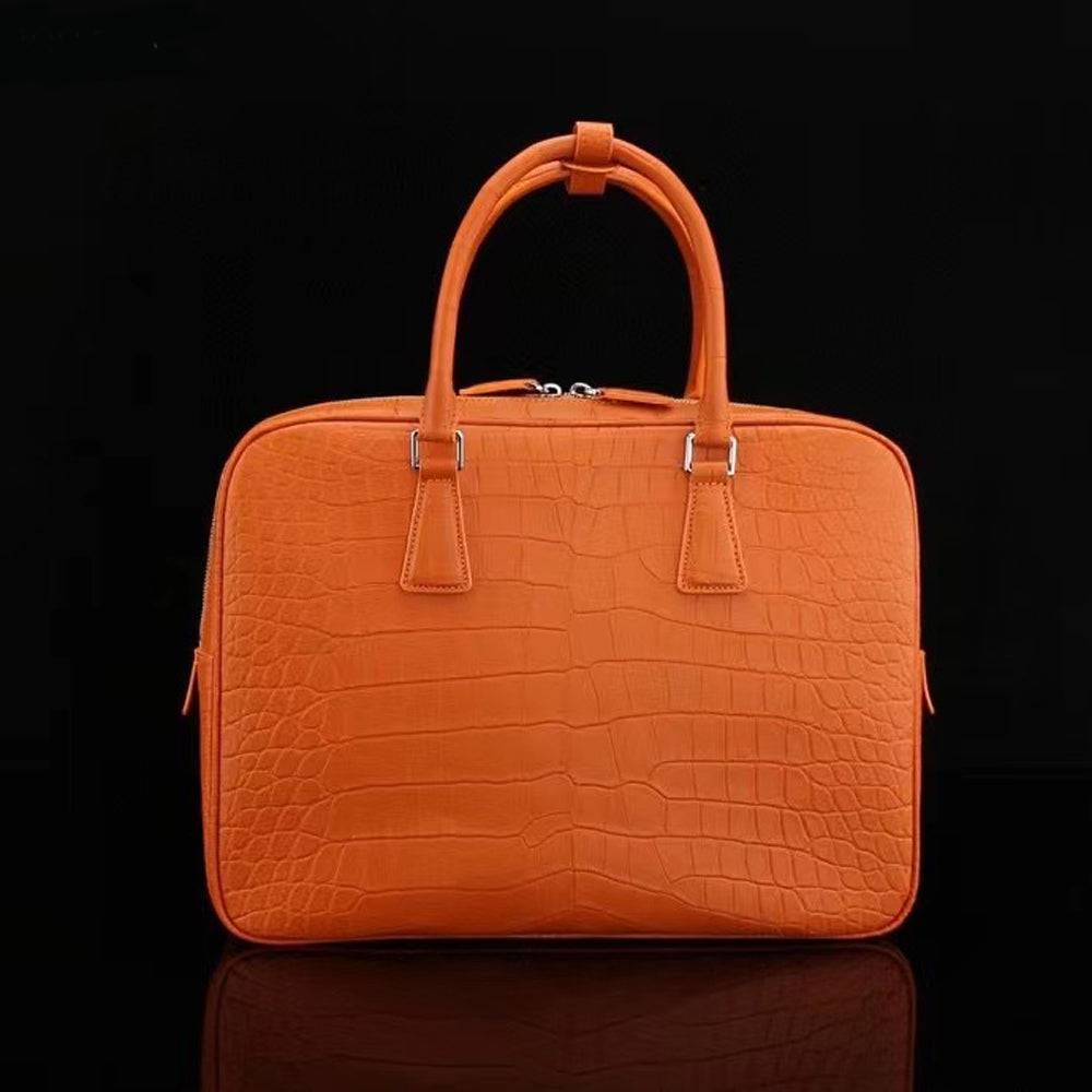 Orange genuine crocodile leather briefcase by Rossie Viren, featuring a sleek design and sturdy handle for professional use.