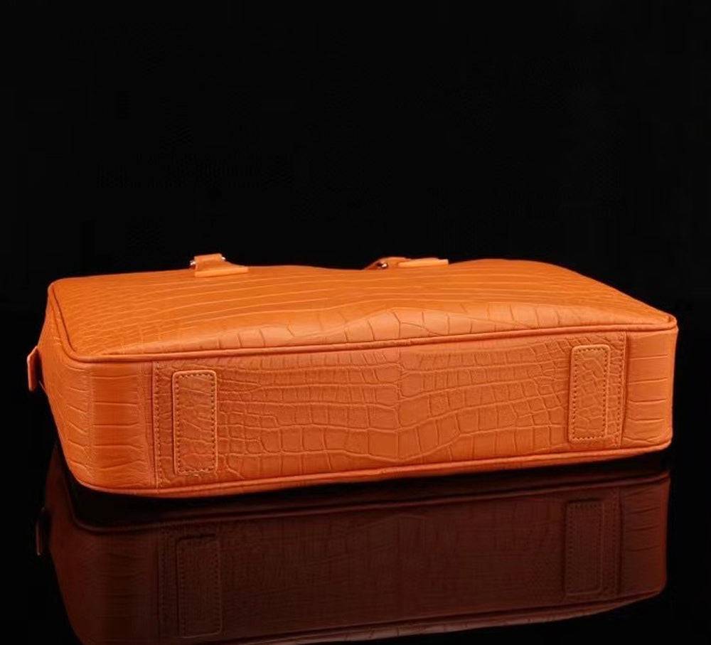 Orange genuine crocodile leather briefcase by Rossie Viren with sturdy handles and sleek design for professional use.