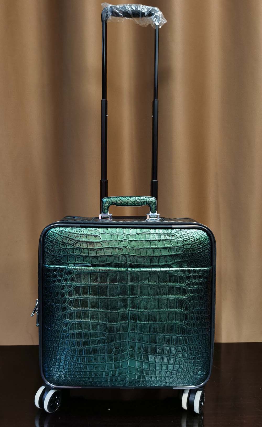 Dark green crocodile leather 15-inch mini carry-on suitcase by Rossie Viren, with sturdy handle and sleek design.