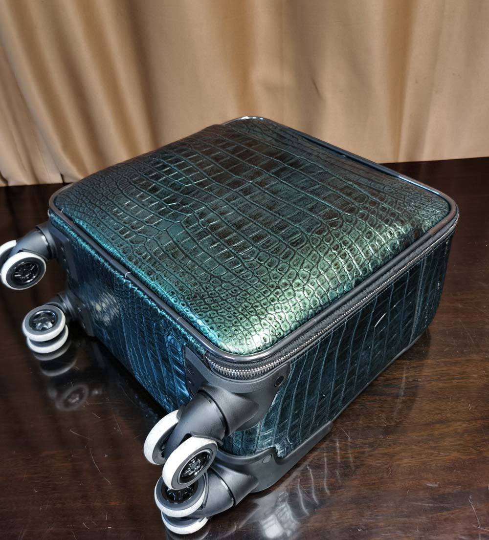 Dark green Crocodile Leather 15-inch mini carry-on suitcase by Rossie Viren, with textured crocodile pattern and sturdy handle.