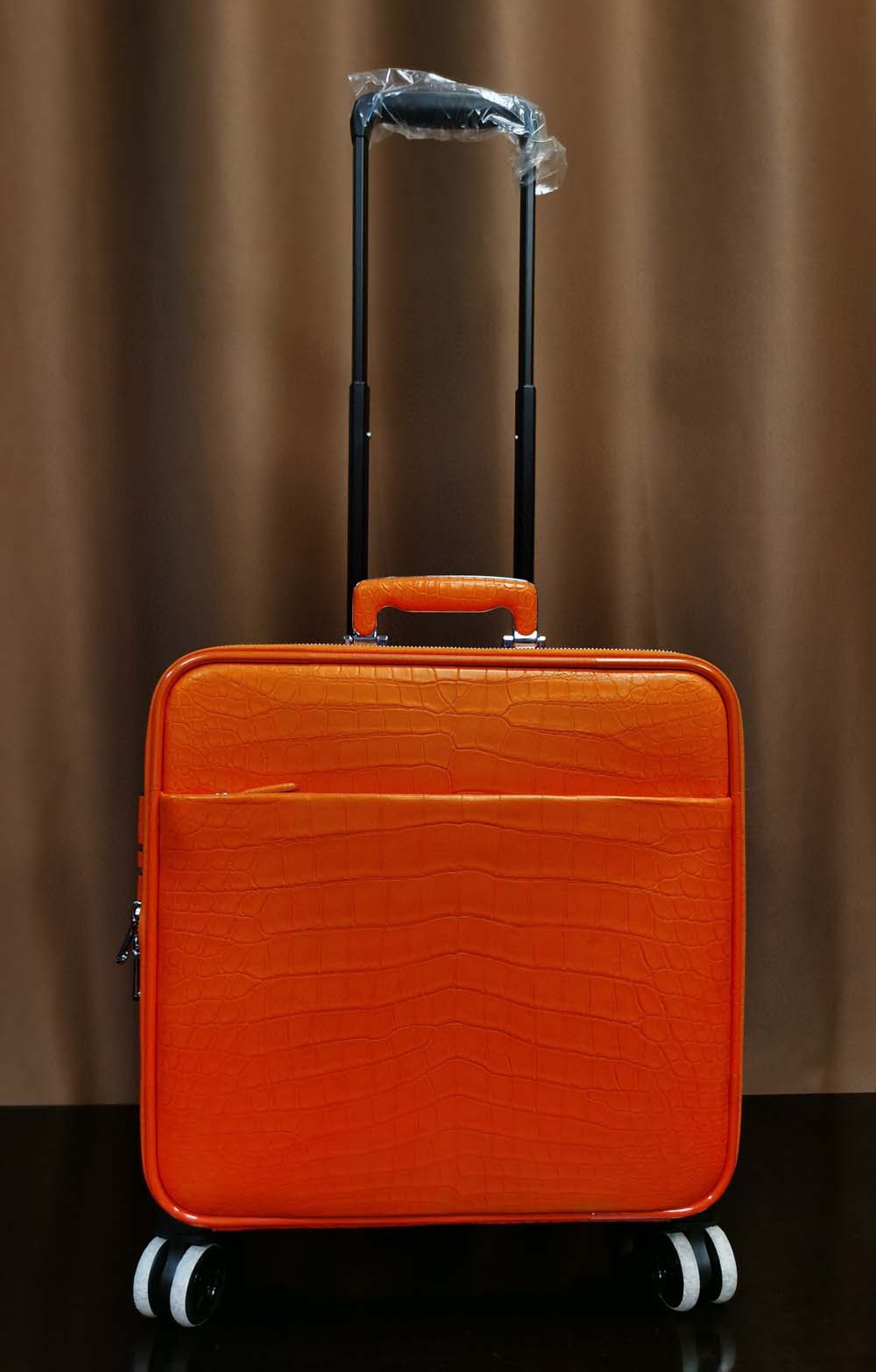Rossie Viren orange crocodile leather 15-inch mini carry-on suitcase with sleek design and textured finish.