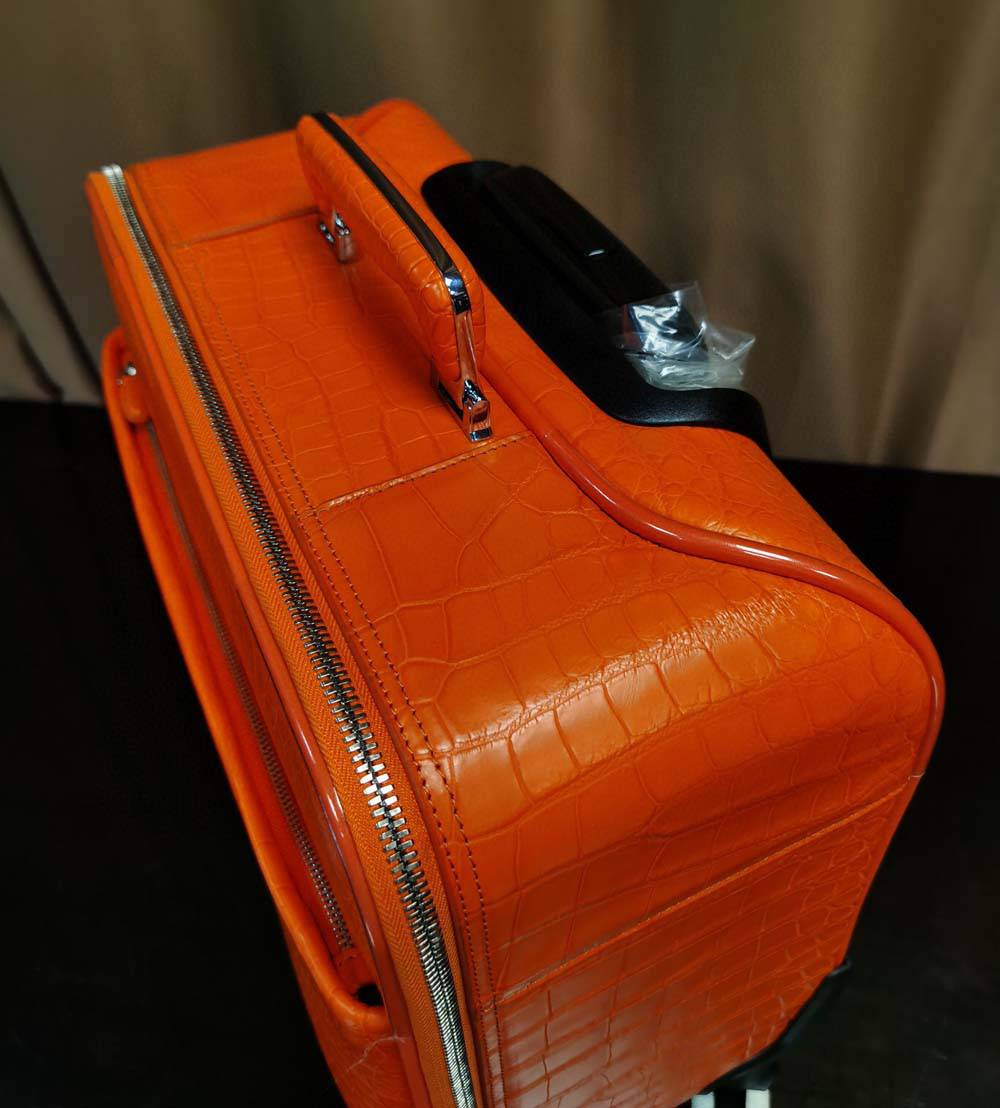 Orange crocodile leather 15-inch mini carry-on suitcase by Rossie Viren, featuring a textured crocodile pattern and compact design.