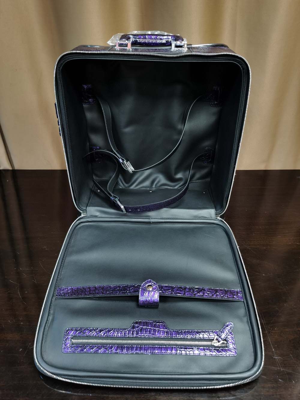 Purple crocodile leather 15-inch mini carry-on suitcase by Rossie Viren, featuring a sleek, textured surface and compact design.